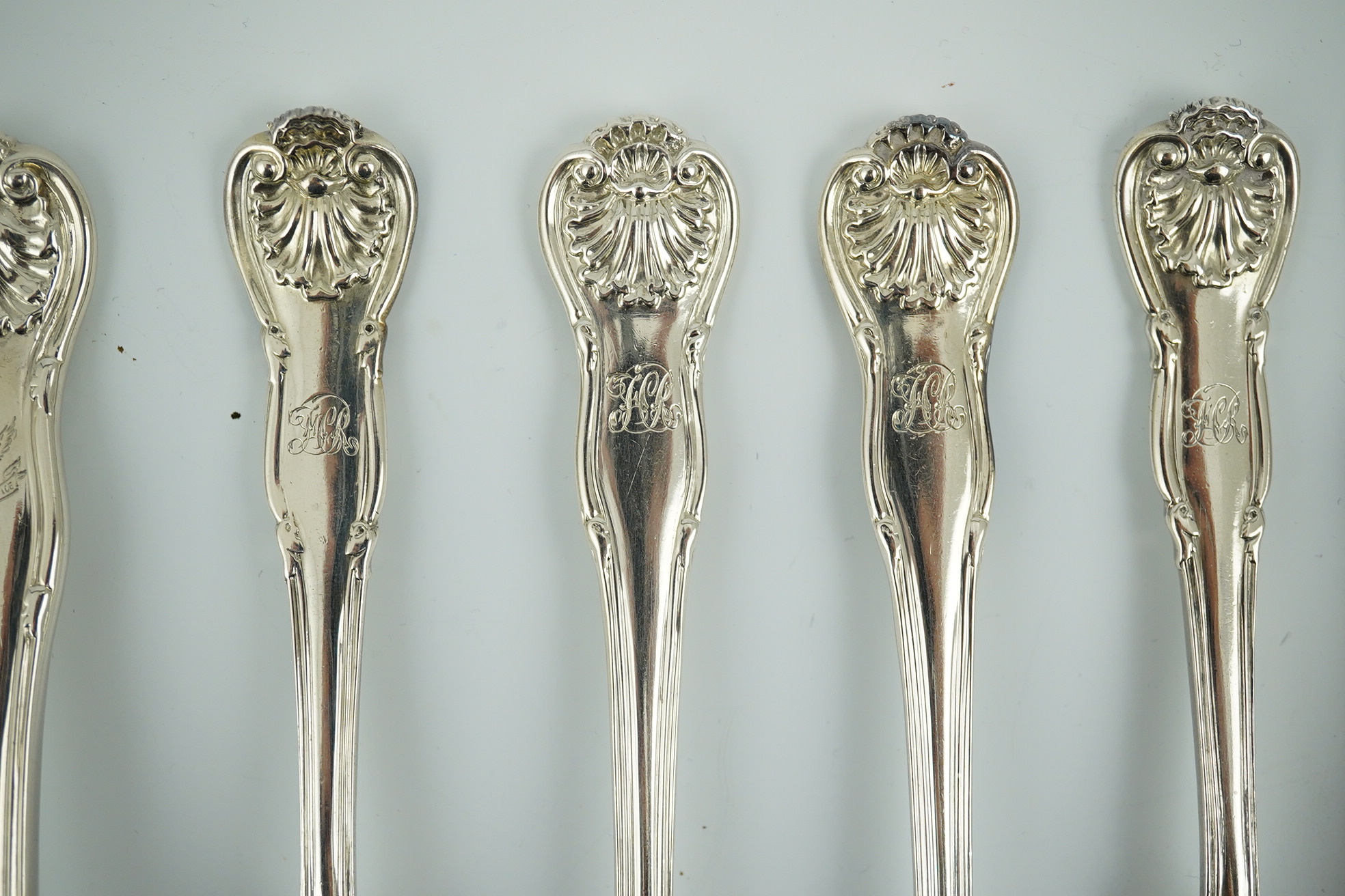 A matched part canteen of George IV and later silver shell scroll pattern flatware